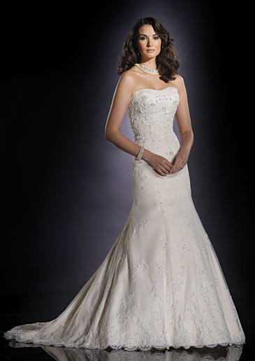 A mermaid style gown, hugging from the chest to below the hips and then dramatically flaring outwards, is a pretty style favored by traditional brides.