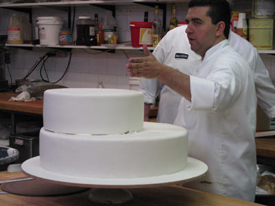 To keep the finished product looking pristine, Buddy coats each cake tier separately in fondant. Fondant is a soft mixture of water, sugar and glucose heated and stirred until it's a little like thick frosting but firmer; it’s great for decorating.