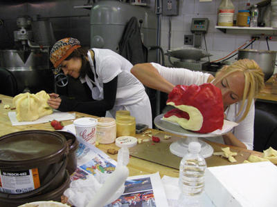 While Buddy prepares the cake, he usually has a couple of assistants on hand to help with the finer details. These two pieces, part of the dragon's head and made of modeling chocolate and cereal, must be completed before being attached to the main cake.