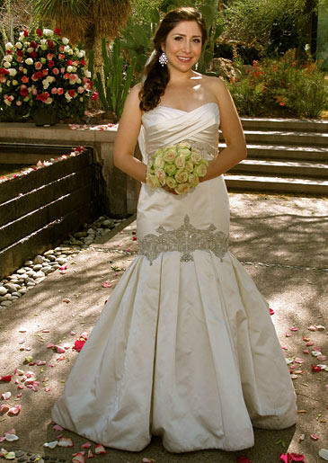 This ivory satin fit and flare gown incorporates ruching at the bustline and crystal beadwork at the dropped waist.