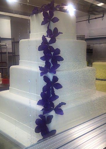 A four-tiered cake with purple flowers, seen at Lackawanna.