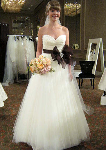A bride's ballerina-inspired tulle ball gown is cinched at the waist with an oversized chocolate bow.