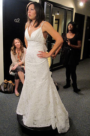 The thin beaded straps of this fit and flare gown match the beadwork beneath the bust.