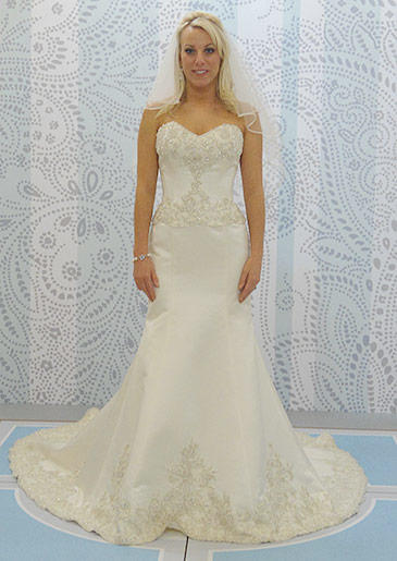 A chic trumpet silhouette makes the bride look even longer and leaner with beadwork on the bodice.