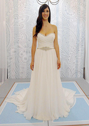 This white strapless wedding gown reads 'Greek goddess' with its artful folds and airy fabric.