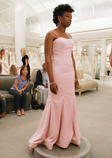 A bubble gum pink sheath with spaghetti straps can be styled with a veil and crystal accessories for the ceremony, or dressed down for a casual reception.