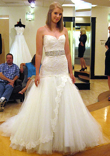 This white lace and tulle gown toes the line between sweet and sexy with its full skirt and curve-hugging bodice.