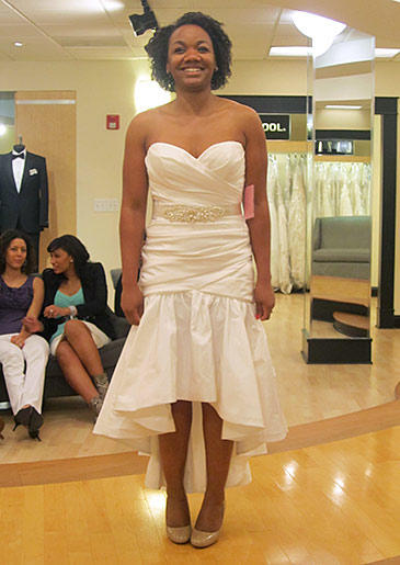 A flirty sweetheart neckline suits the informal high-low hemline of this satin gown.