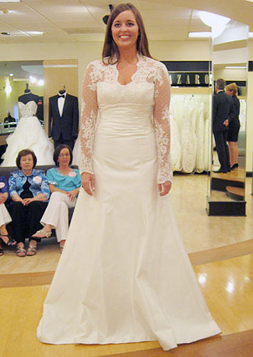 An ivory A-line gown with lace sleeves recalls Kate Middleton's famous wedding dress.