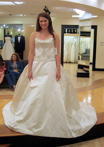 Cool, crisp satin is simple enough for the skirt of this ball gown, but a silver beaded bodice makes the look more formal.