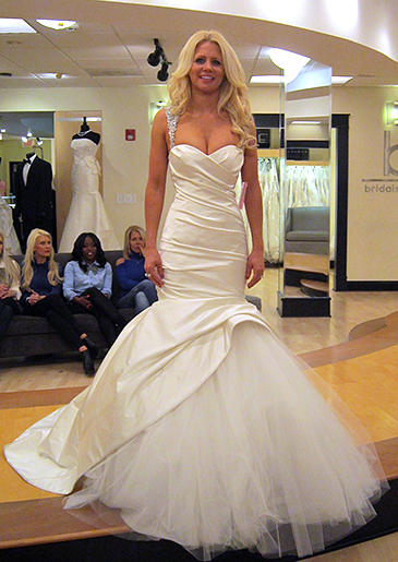 A low-cut sweetheart neckline is held up by wide crystal-embellished straps.
