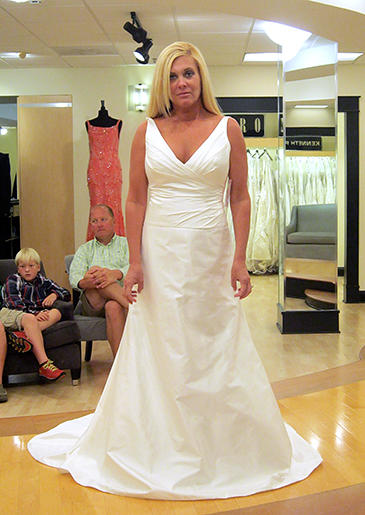 An unfussy white A-line gown with plunging V-neck is perfect for an encore or mature bride.