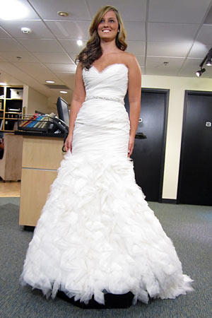 Brittany wears Rivini Style Lorenza.
Fabric: silk organza/tulle
Description: mermaid fit draped bodice with beaded belt and organza skirt
Color: ivory
Price: $$$$$