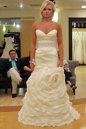 Pamela wears Rivini Style Camelia.
Fabric: silk satin organza/silk double organza
Description: dropped waist with sash and floral skirt
Color: ivory
Price: $$$$$