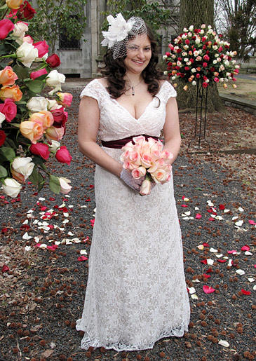 The high empire waist of this dress is emphasized by a dark sash.