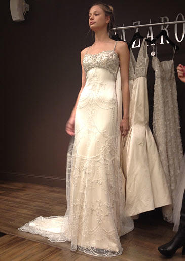 This empire waist Lazaro gown has a beaded bustline and dreamy beaded overlay.