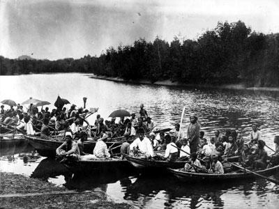 Sea gypsies navigate their boats through a river near Bangkok, Thailand.