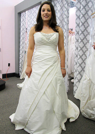 Contemporary wedding dresses don't feature all-over beadwork; instead, the embellishment is focused, like this beaded neckline.