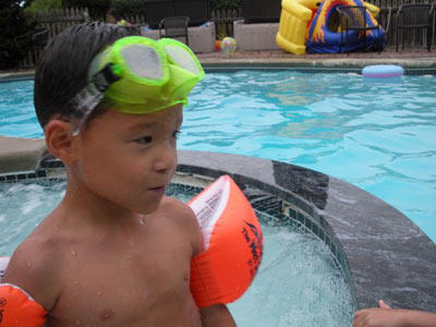 Aaden plays it safe in the pool with floaties and goggles. Keep practicing!