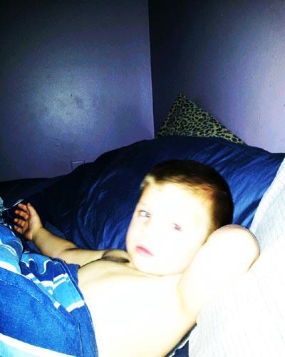 This is a picture I took of my son when I noticed on the wall there was a light from the flash of the camera. It looks to me like a face in it, it almost looks like another kid of mine. I'm pregnant so I was wondering if it could be the soul of another child or maybe even just a spirit?
-- Kelly H.