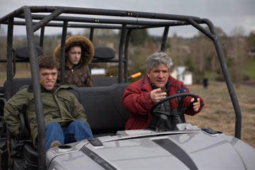 Zach, Molly and Matt ride a golf cart around the family's property in Oregon.