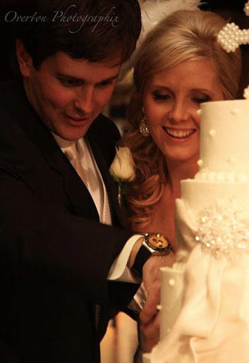 Holly and Robert cut the bride's cake while "So This Is Love" from Disney's "Cinderella" plays. "We had to have a princess song in there somewhere," Holly explains. While Robert cut his groom's cake, the DJ played the University of Alabama fight song.
