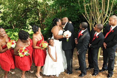 The bride and groom exchange a smooch.