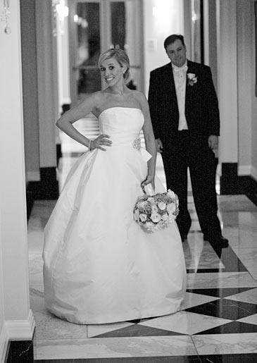 Stephanie's groom, John, admires her dress.