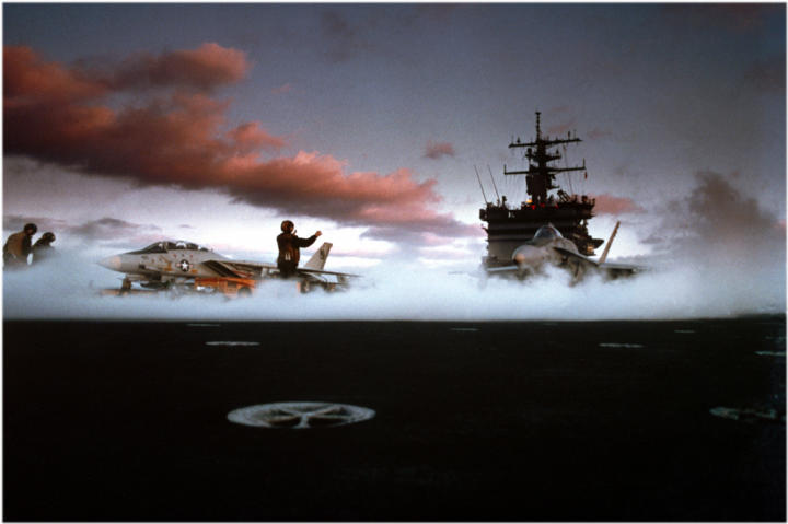 An F-14 and an F/A-18 Hornet get ready to take off.
