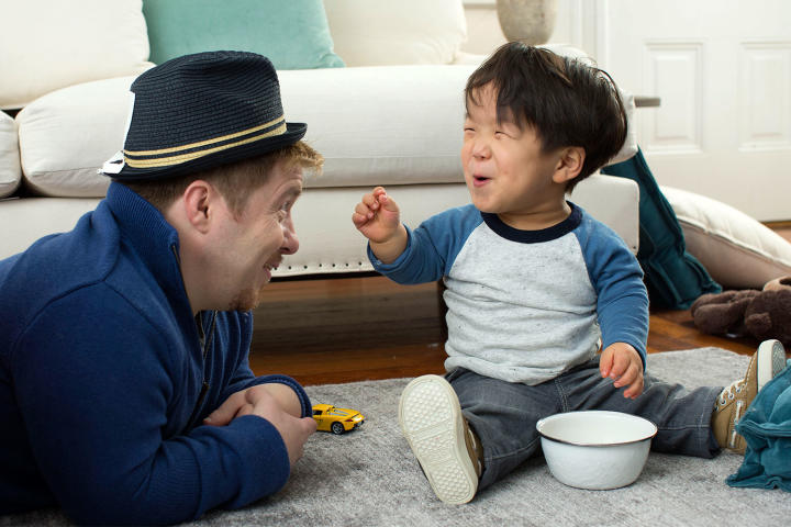 Will laughs at Dad in the silly hat.