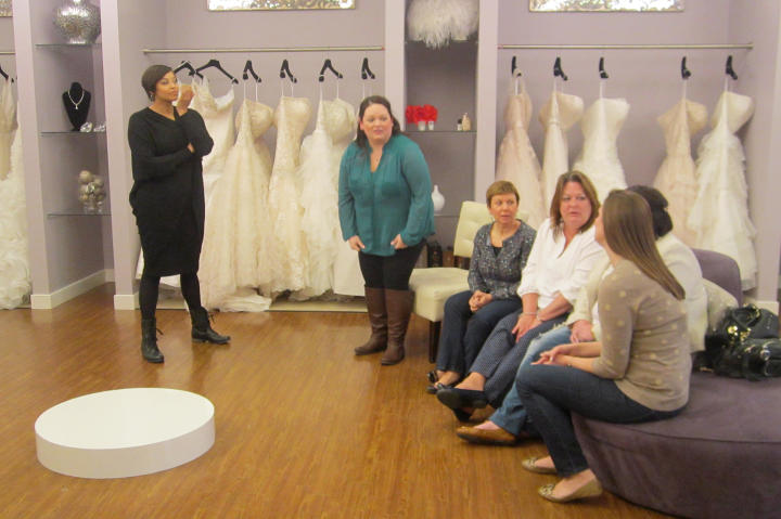 Step into Curvaceous Couture, the bridal salon operated by sisters Yukia and Yuneisia. Here, Yuneisia greets bride Christen and her entourage.