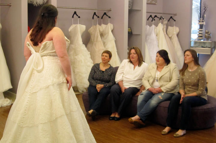 Christen shows her family a classic A-line gown.