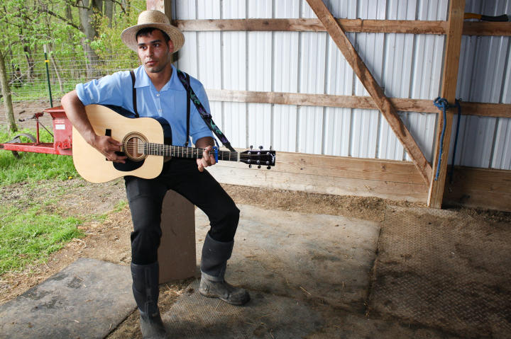 Playing the guitar (Johnny Cash-style) is a welcome respite after mucking the stalls.