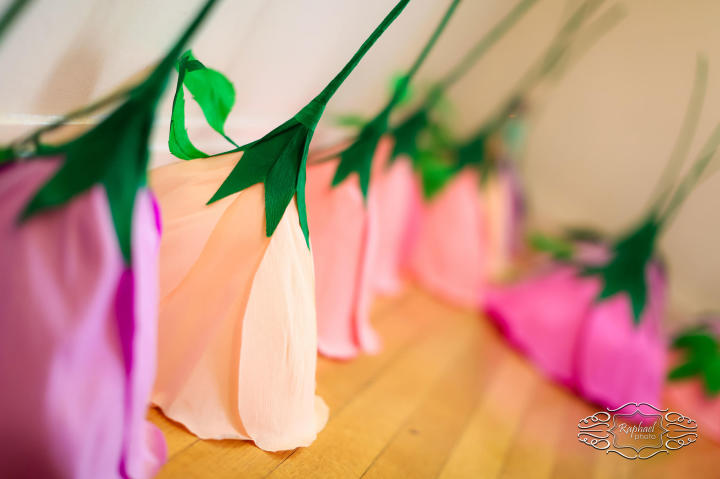 Instead of traditional floral bouquets, Kelly and her bridal party carried giant paper flowers. The bouquets and floral reception decor were made by Flower Bazaar on Etsy.