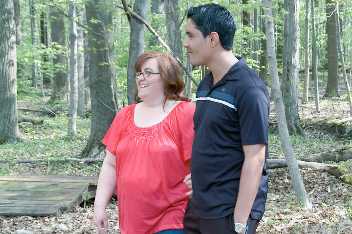 Danielle and Mohamed are all smiles as they tour the grounds of a prospective wedding venue.