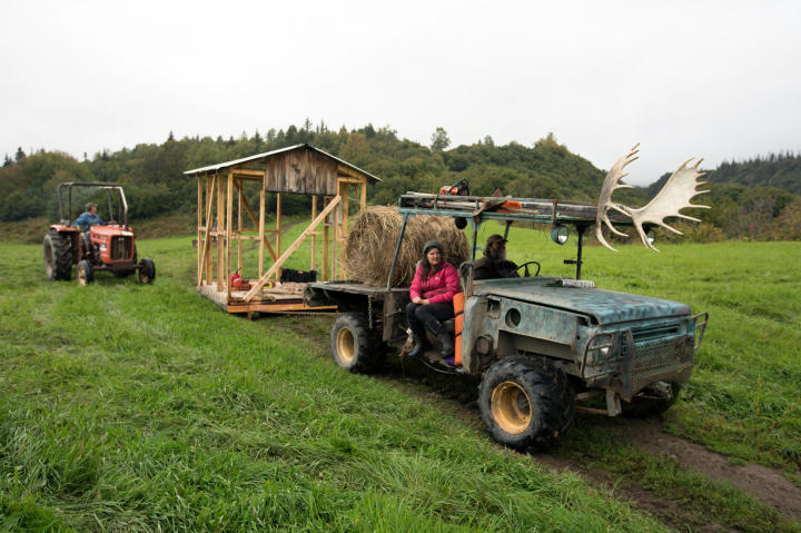 Jane Kilcher, Shane Kilcher and Otto Kilcher move supplies and equipment to the beach to load onto the barge to Perl Island.