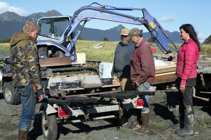 Grady Avant, Shane Kilcher, Otto Kilcher and Jane Kilcher unload up supplies they brought to Perl Island.