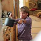Amy cooks in the family's custom-built kitchen that better accommodates the needs of a family of little people. The lowered countertops, shelves and appliances mean Amy doesn't have to reach or use a step stool to navigate through her kitchen.