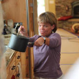 Amy cooks in the family's custom-built kitchen that better accommodates the needs of a family of little people. The lowered countertops, shelves and appliances mean Amy doesn't have to reach or use a step stool to navigate through her kitchen.