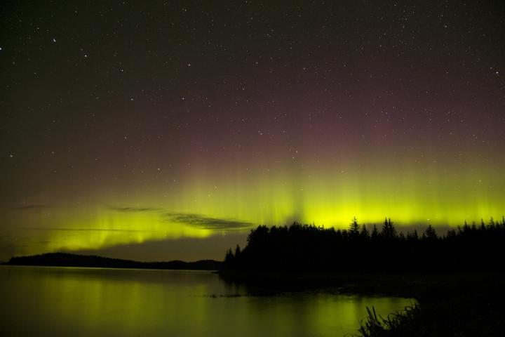 A starry sky tinted with the purple and yellow hues.
