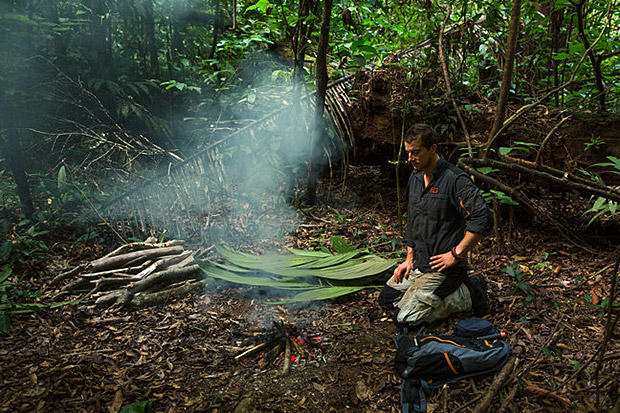Getting a fire going in a damp jungle is often a challenge but Bear shows the best ways to find the right fuel and get a flame going. Here he's preparing a fire that can produce clouds of smoke to signal rescuers flying above.