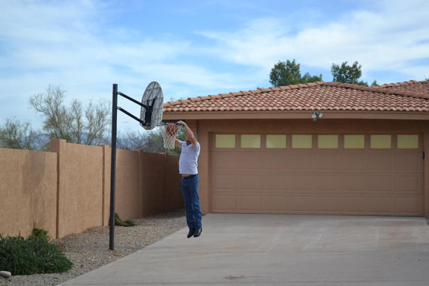 Ed Rosenberg dunks a basketball in front of his newly acquired property.