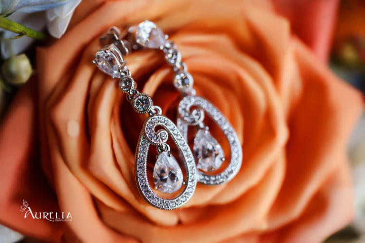 Karen's earrings lay on her orange bouquet.