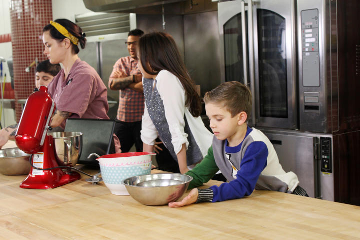 All of the Valastro kids gather around the cooking table with Ashley Holt, last season's winner of "Next Great Baker."