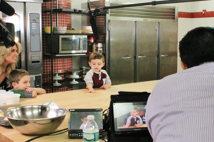 Carlo gets right to work introducing himself on camera, while proud Dad, "Cake Boss" Buddy Valastro, watches.