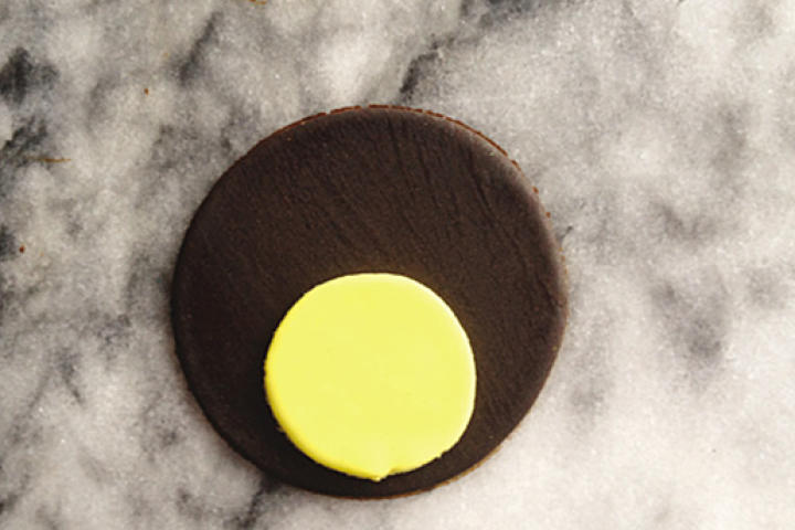 Place the 3-inch circle on the surface of the ganache-covered cupcake