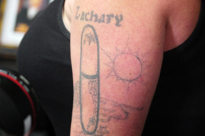 Before: Amanda shows off her hated tattoo, which she says gets mistaken for a ‘sexual apparatus.'