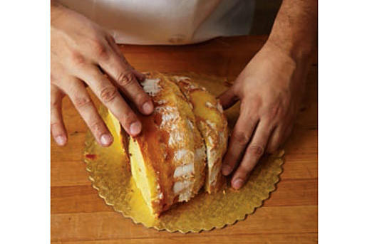 Now, turn the larger piece of cake frosting side down, and put the piece you sliced off beside it. This is the shape of your turkey.