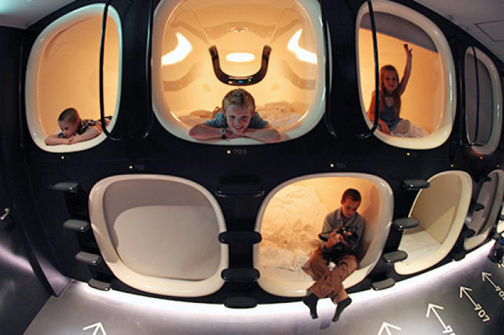 The kids enjoying their rooms in a Japanese capsule hotel.