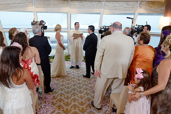 Buddy and Lisa exchange vows while their family looks on.